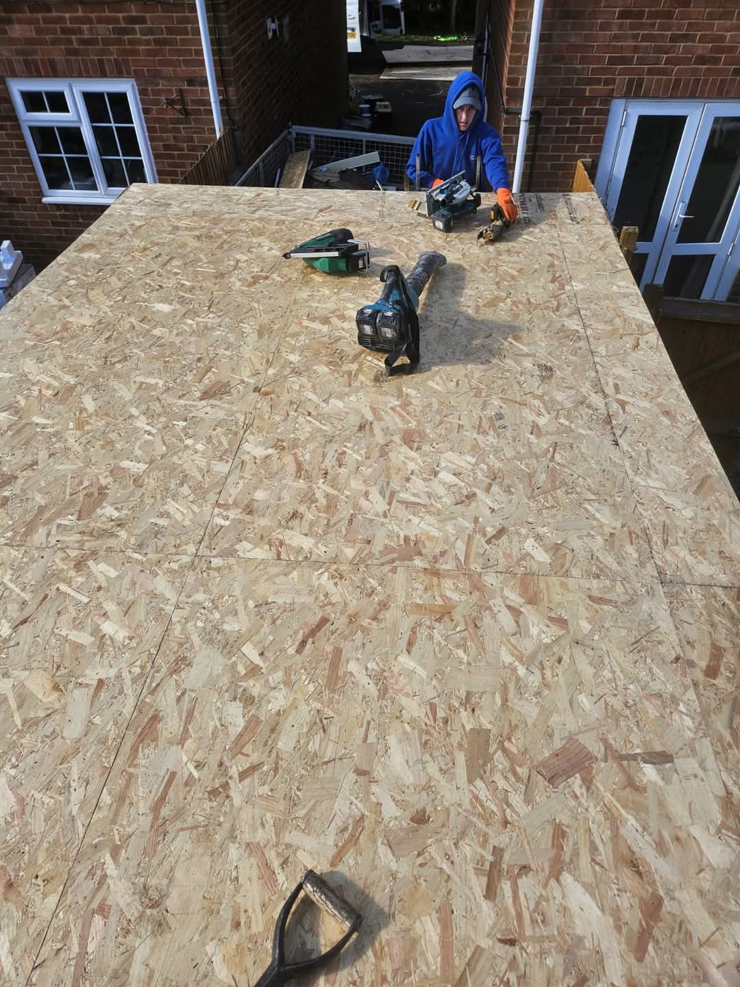GAC Roofline roofer boarding a new flat roof deck